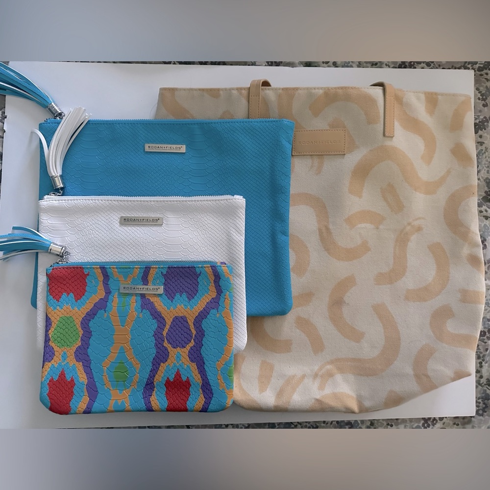Set of (4) Rodan & Fields branded bags - 3 clutches/1 tote